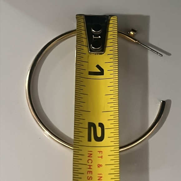 Gold tone hoop earrings with beautiful crystal accent at the top of the earrings - Picture 3 of 4